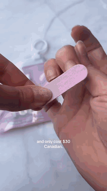 Filing a natural nail before applying press-ons