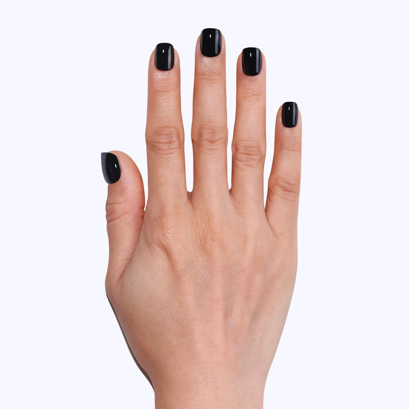 Close-up of a glossy black press-on manicure