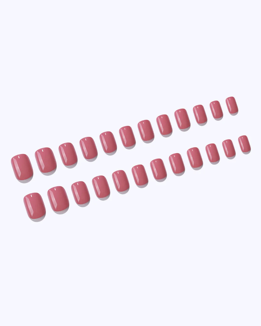 A full set of pink press-on nails laid out in graduated sizes